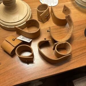 8, tan leather tablecloth holders